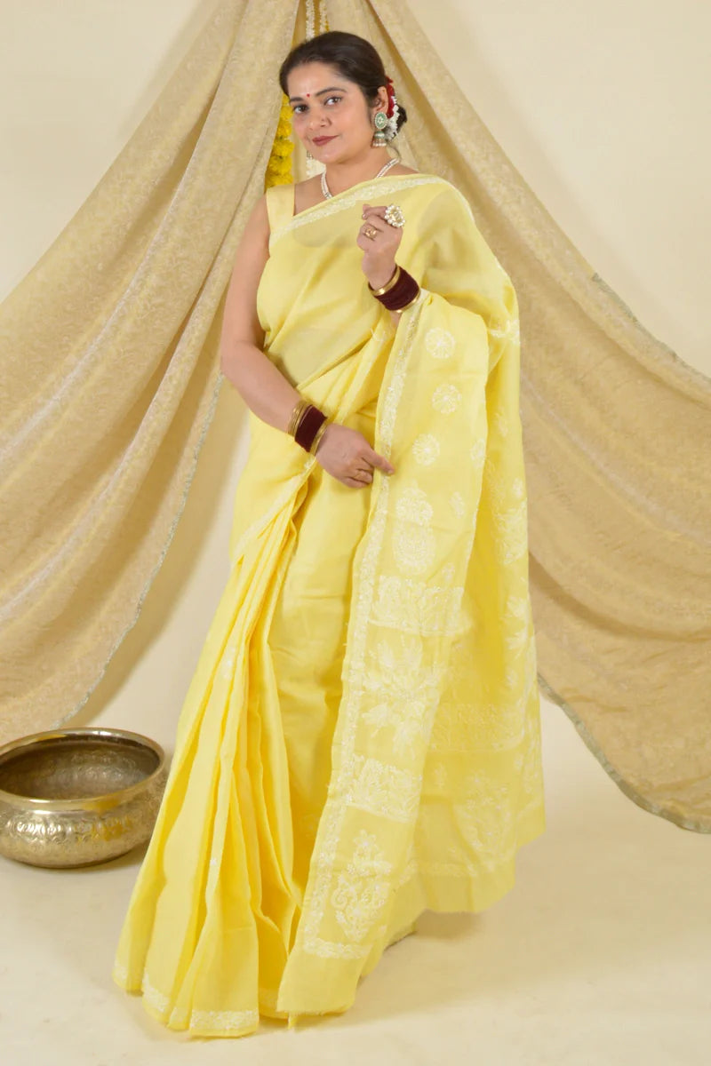 Handcrafted Yellow Saree with intricate Lucknowi Chikankari embroidery and a matching blouse, ideal for festive and wedding occasions.