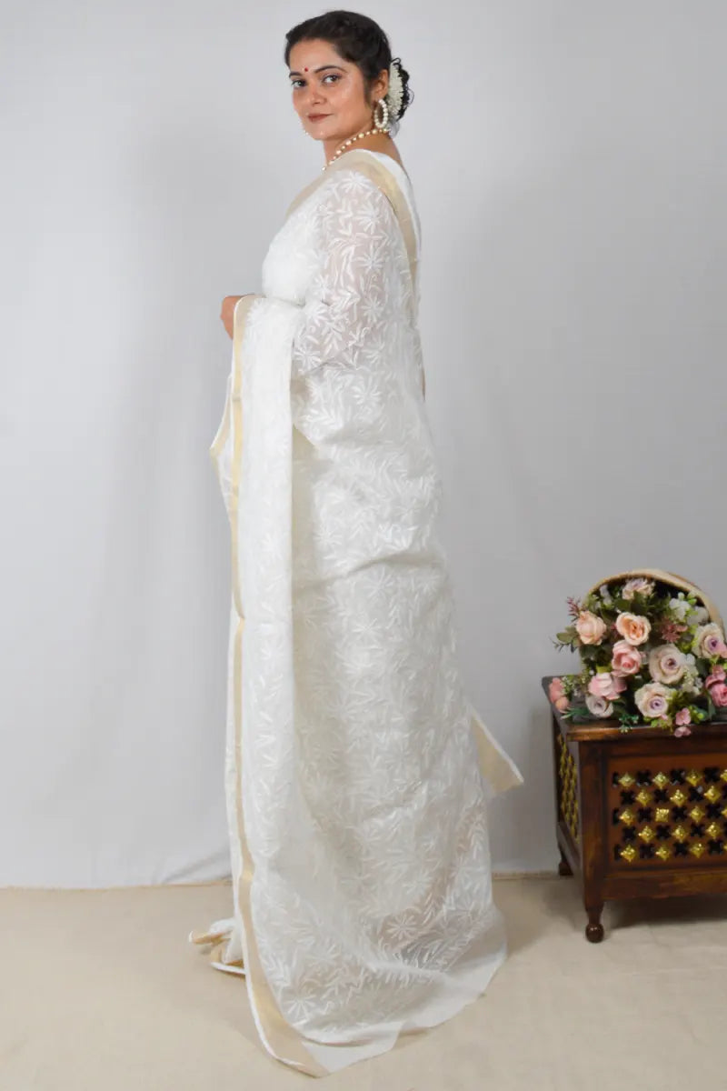 White Kota cotton saree with Lucknowi Chikankari and zari border, paired with matching blouse – handcrafted by MeMaana.
