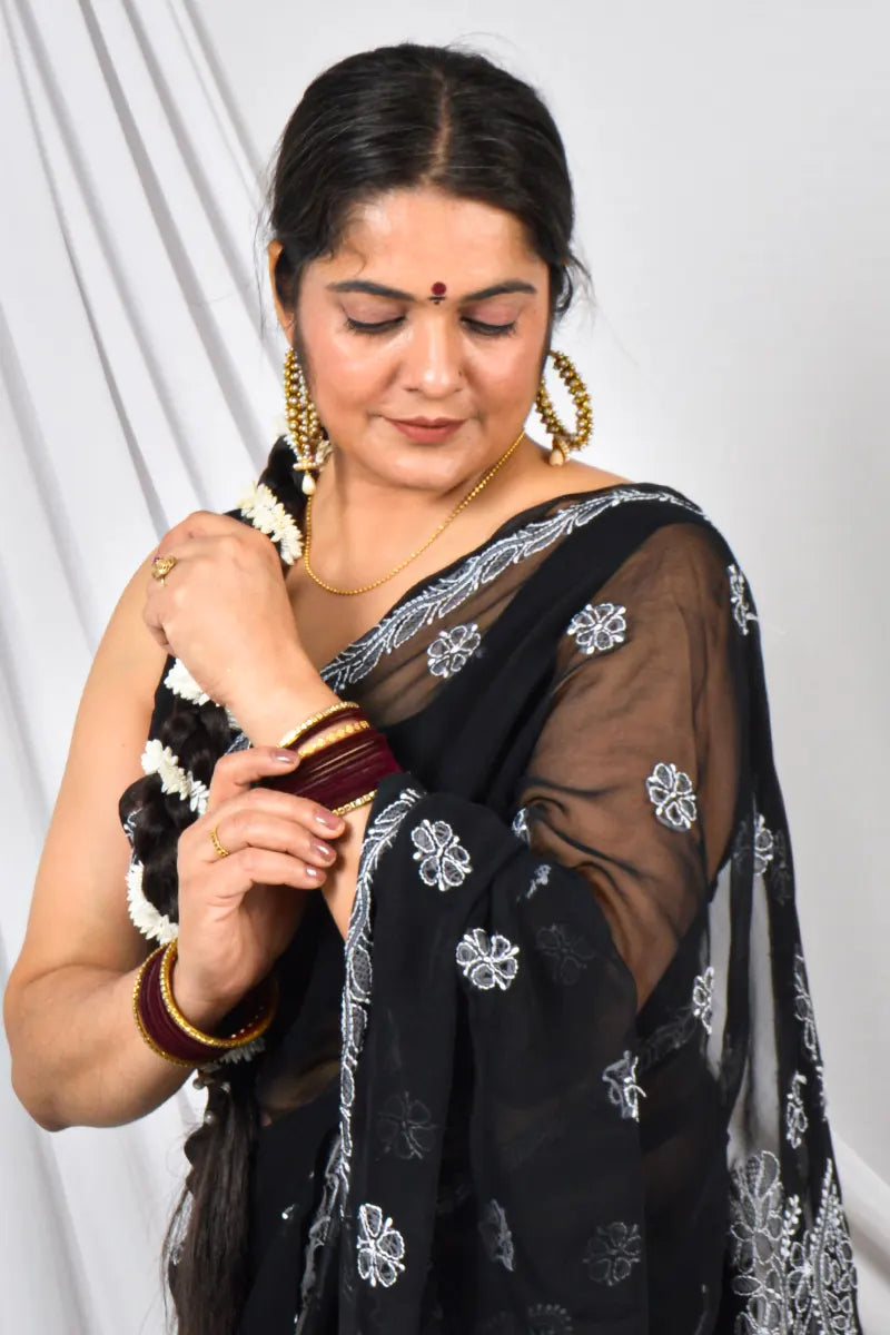 Handcrafted Black Georgette saree intricate Lucknowi Chikankari embroidery and a matching blouse, ideal for festive and wedding occasions.