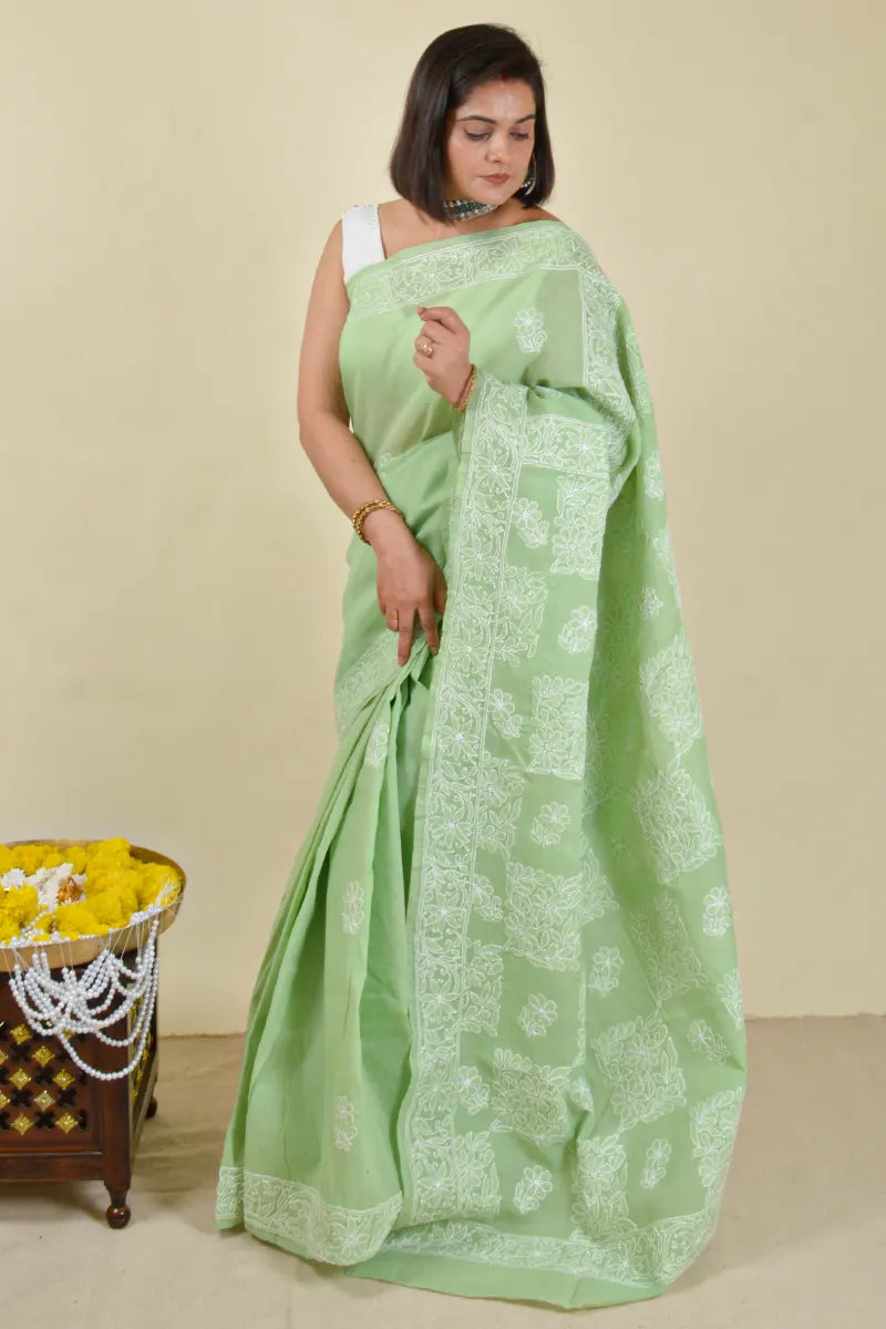 Handcrafted Cotton Green saree with intricate Lucknowi Chikankari embroidery and a matching blouse, ideal for festive and wedding occasions.