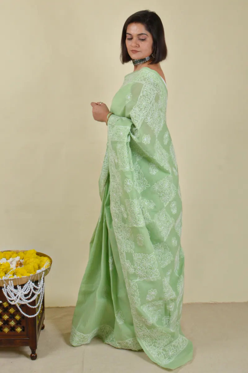 Handcrafted Cotton Green saree with intricate Lucknowi Chikankari embroidery and a matching blouse, ideal for festive and wedding occasions.