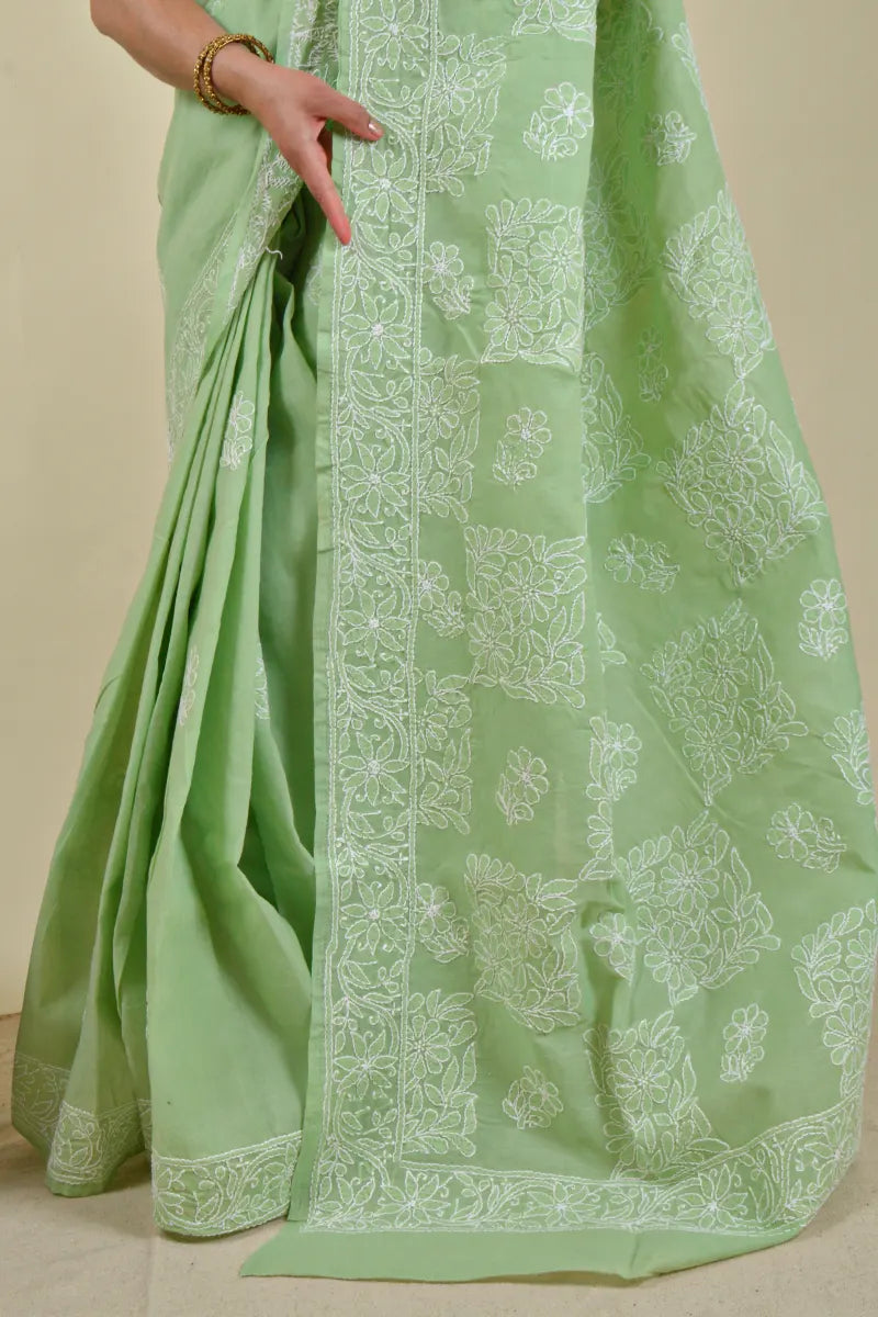 Handcrafted Cotton Green saree with intricate Lucknowi Chikankari embroidery and a matching blouse, ideal for festive and wedding occasions.