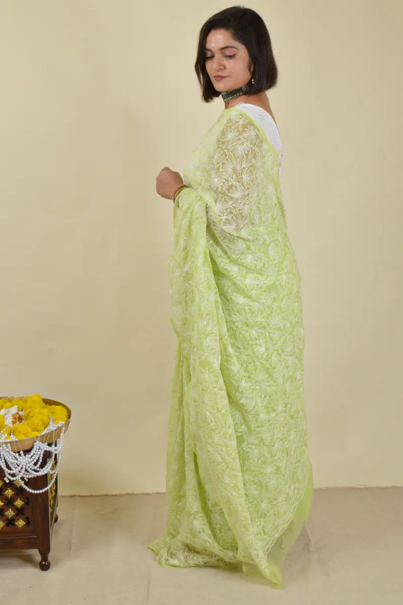 Handcrafted Green Georgette Saree with intricate Lucknowi Mukaish
Tepchi Chikankari embroidery and a matching blouse, ideal for festive and wedding occasions.