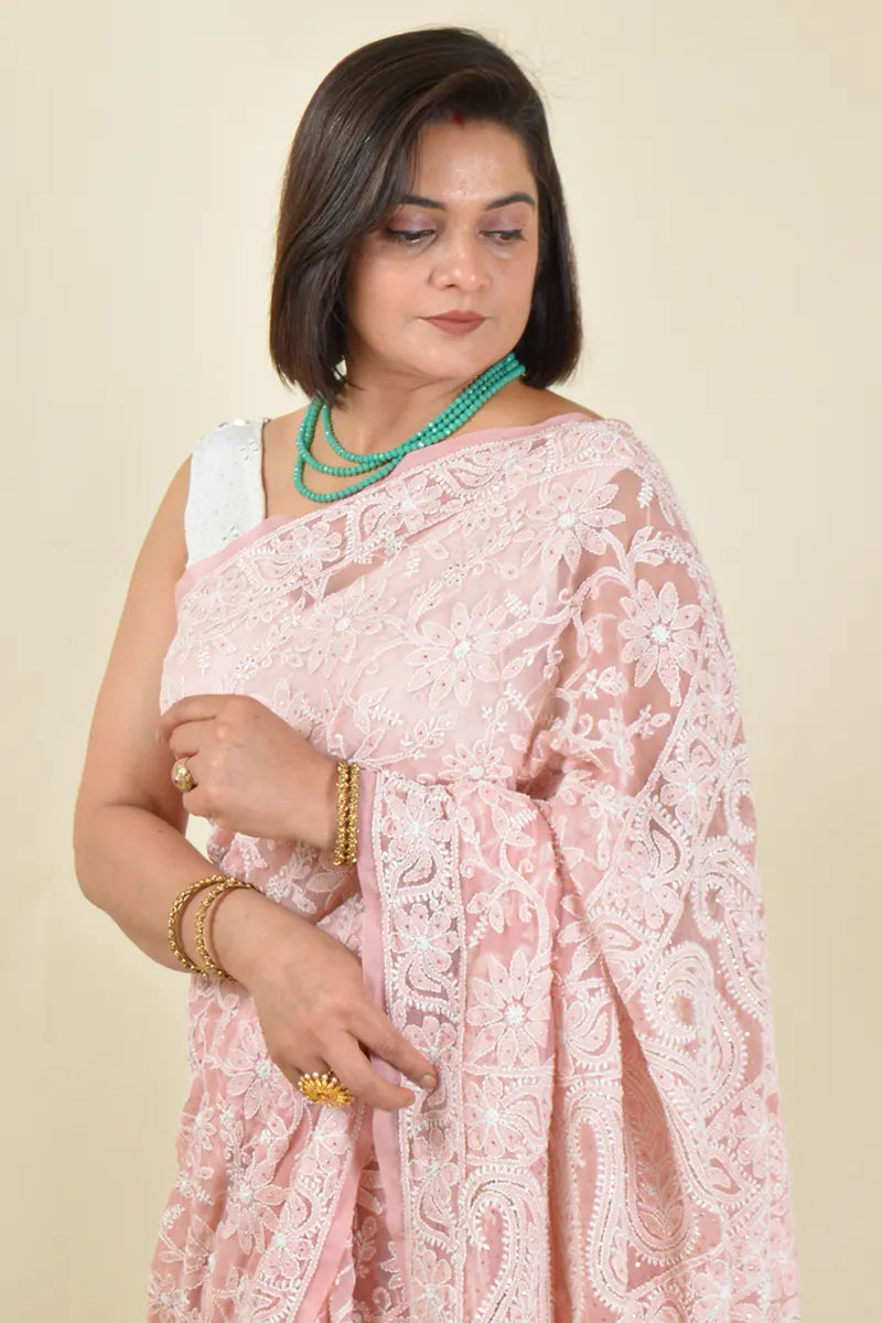Handcrafted Peach Georgette Saree with intricate Lucknowi Mukaish work Chikankari embroidery and a matching blouse, ideal for festive and wedding occasions.