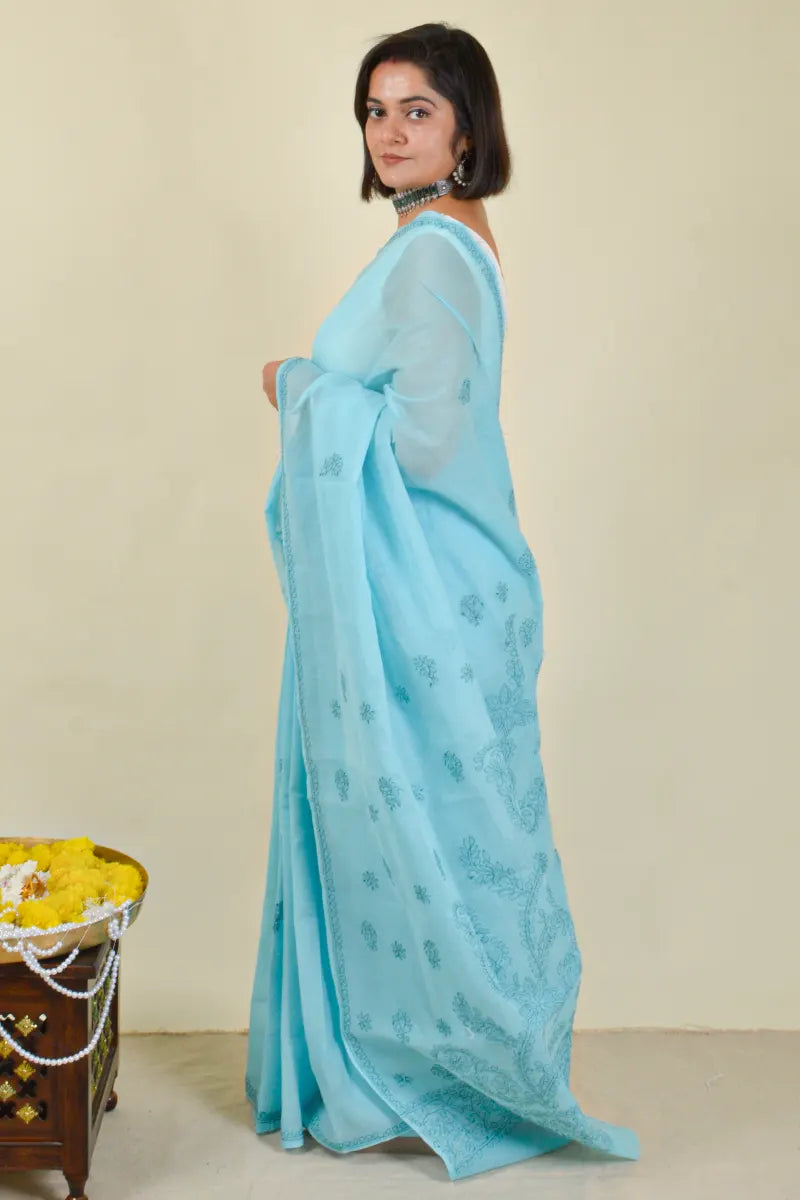 Handcrafted Blue Cotton saree with intricate Lucknowi Chikankari embroidery and a matching blouse, ideal for festive and wedding occasions.