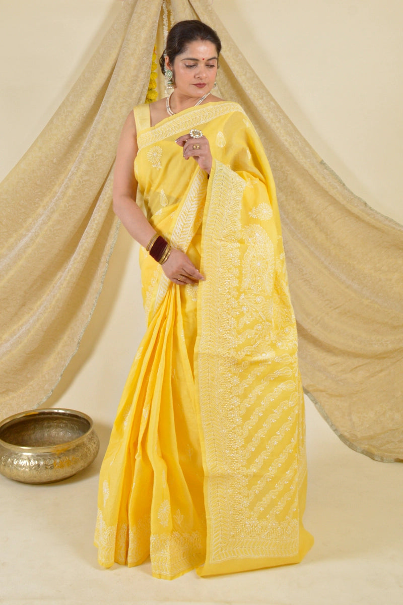 Handcrafted Yellow Cotton Saree with intricate Lucknowi Chikankari embroidery and a matching blouse, ideal for festive and wedding occasions.