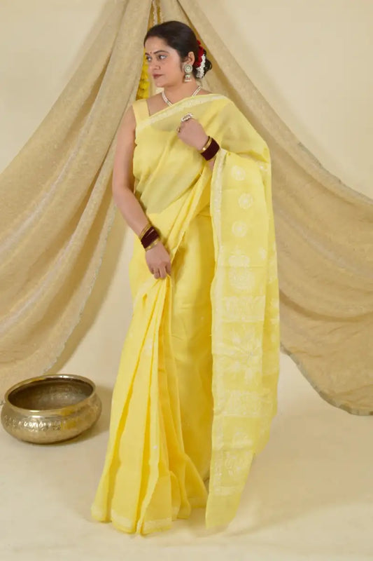 Handcrafted Yellow Saree with intricate Lucknowi Chikankari embroidery and a matching blouse, ideal for festive and wedding occasions.
