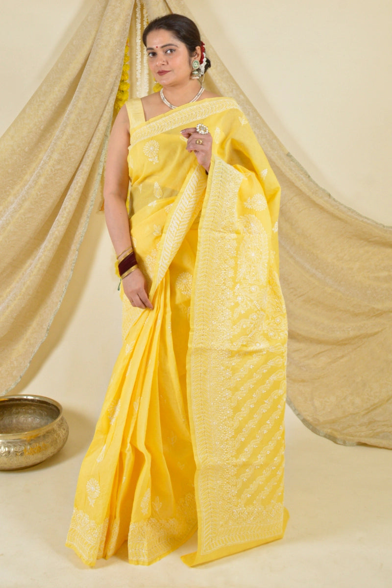 Handcrafted Yellow Cotton Saree with intricate Lucknowi Chikankari embroidery and a matching blouse, ideal for festive and wedding occasions.