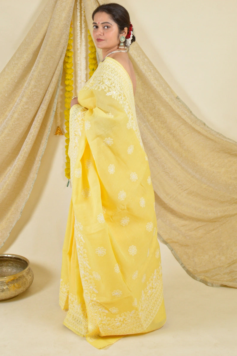 Handcrafted Yellow Cotton saree with intricate Lucknowi Chikankari embroidery and matching blouse, ideal for weddings and festive occasions.