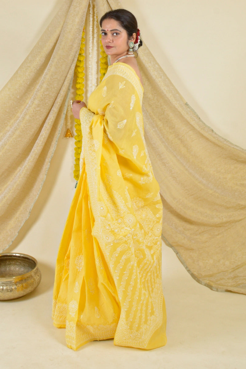 Handcrafted Yellow Cotton Saree with intricate Lucknowi Chikankari embroidery and a matching blouse, ideal for festive and wedding occasions.