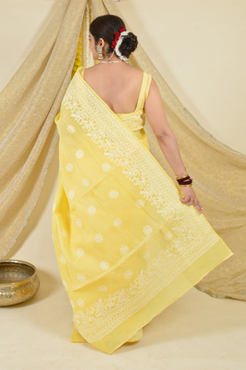 Handcrafted Yellow Cotton saree with intricate Lucknowi Chikankari embroidery and matching blouse, ideal for weddings and festive occasions.
