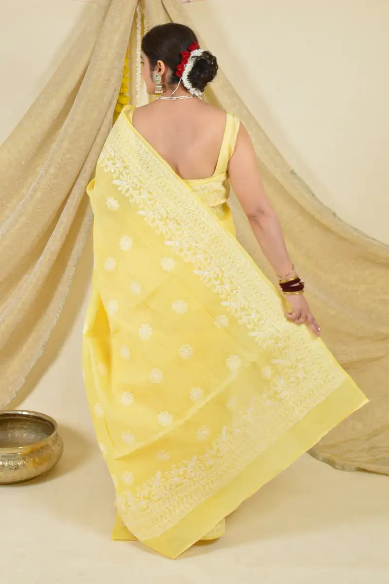 Handcrafted Yellow Cotton saree with intricate Lucknowi Chikankari embroidery and matching blouse, ideal for weddings and festive occasions.