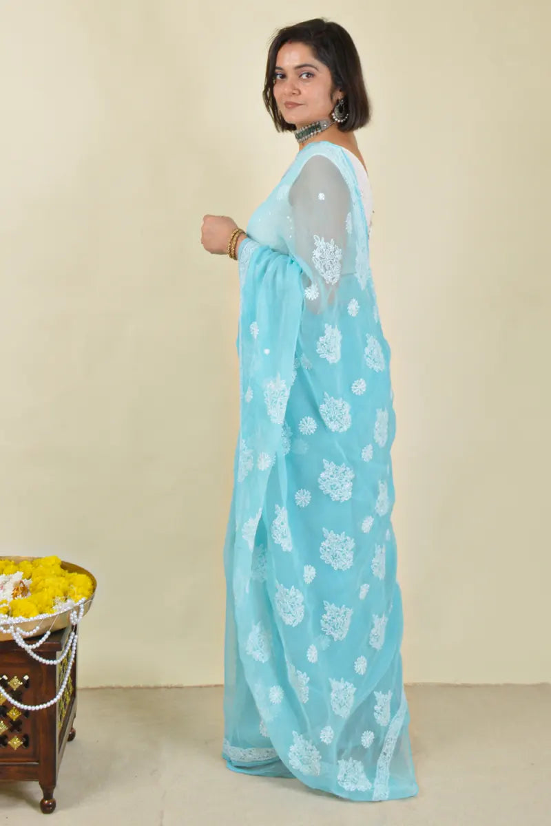 Handcrafted Sky Blue Georgette Saree with intricate Lucknowi Chikankari embroidery and a matching blouse, ideal for Festive and wedding occasions.