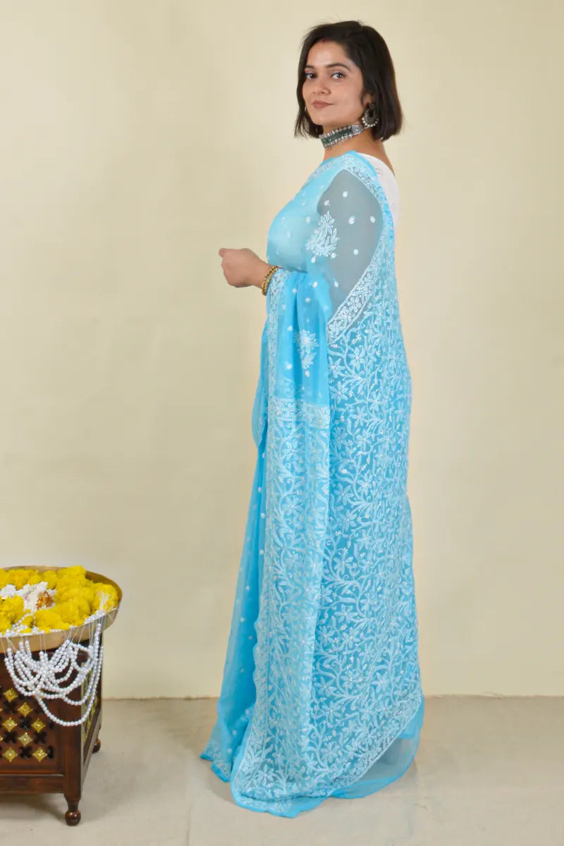 Handcrafted Sky Blue saree with intricate Lucknowi Chikankari embroidery and a matching blouse, ideal for festive and wedding occasions.