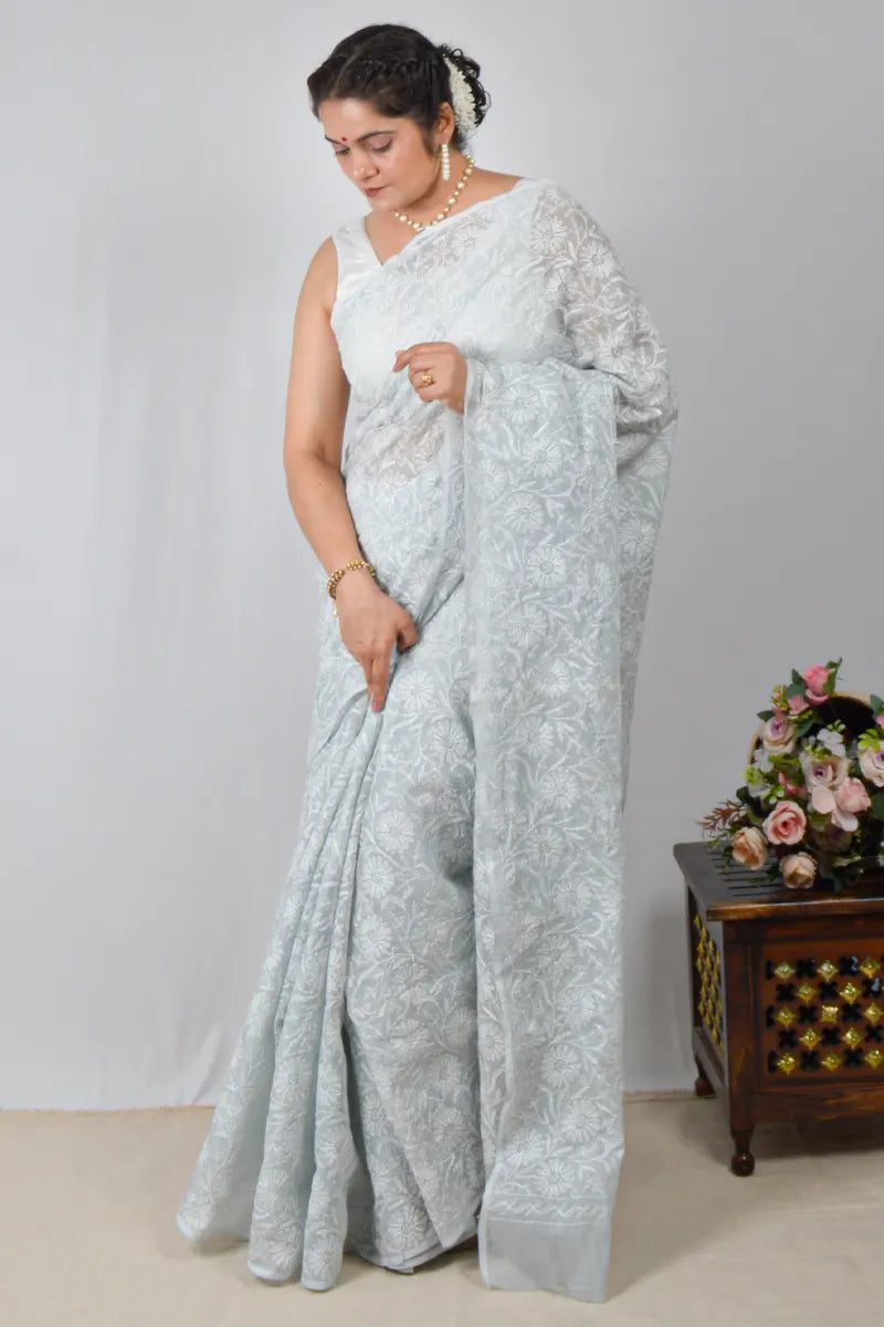 Light gray Kota cotton saree with hand-embroidered Lucknowi Chikankari and matching blouse – breathable and handcrafted ethnic saree by MeMaana.