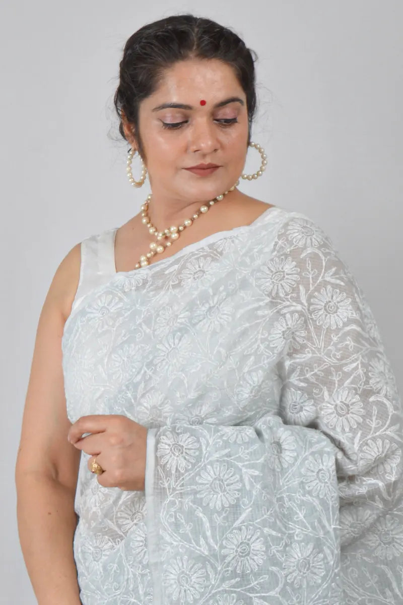 Light gray Kota cotton saree with hand-embroidered Lucknowi Chikankari and matching blouse – breathable and handcrafted ethnic saree by MeMaana.