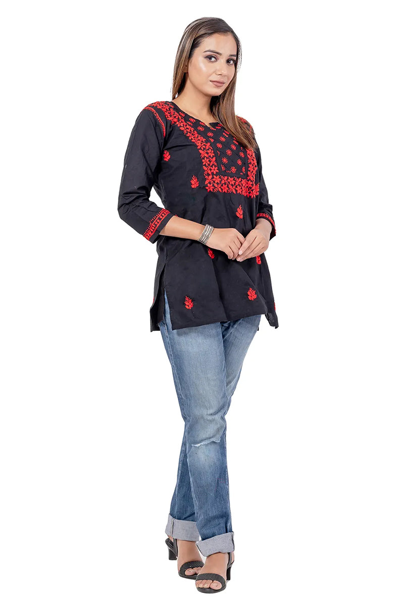 Fabnuma Handcrafted Chikankari Black Cotton Short Top with red embroidery worn with jeans and heels on model.