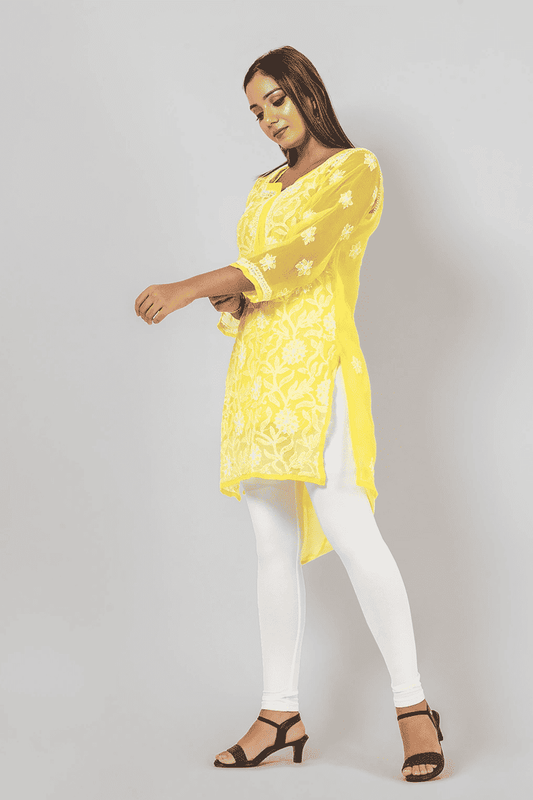 Fabnuma Handcrafted Chikankari Yellow Georgette Short Top with intricate white embroidery on model.