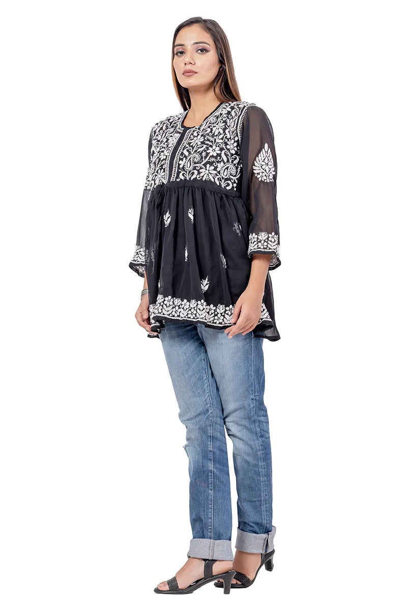 Model wearing Fabnuma Handcrafted Chikankari Black Georgette Short Tops with intricate white embroidery and sheer sleeves.