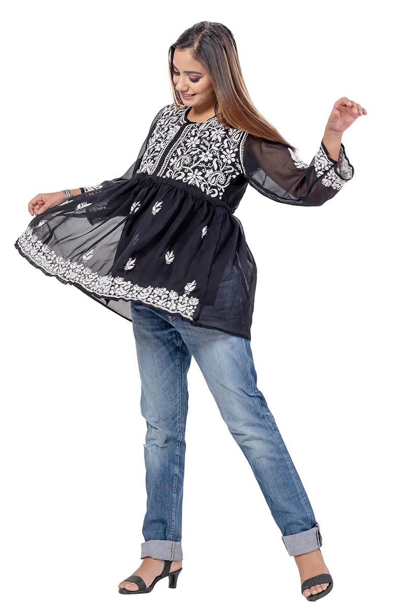 Woman wearing Fabnuma Handcrafted Chikankari Black Georgette Short Tops with intricate white embroidery.