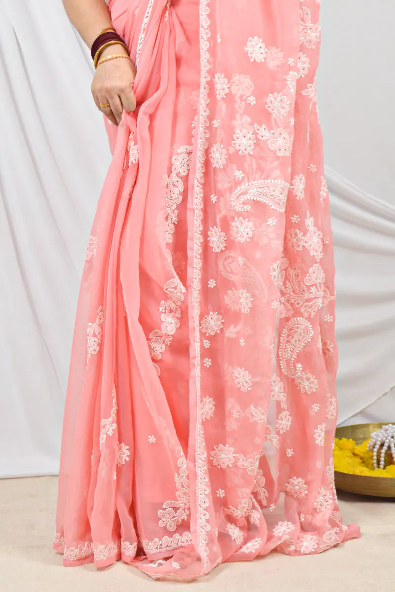 Handcrafted Peach Georgette saree with Muakish intricate Lucknowi Chikankari embroidery and a matching blouse, ideal for festive and wedding occasions.