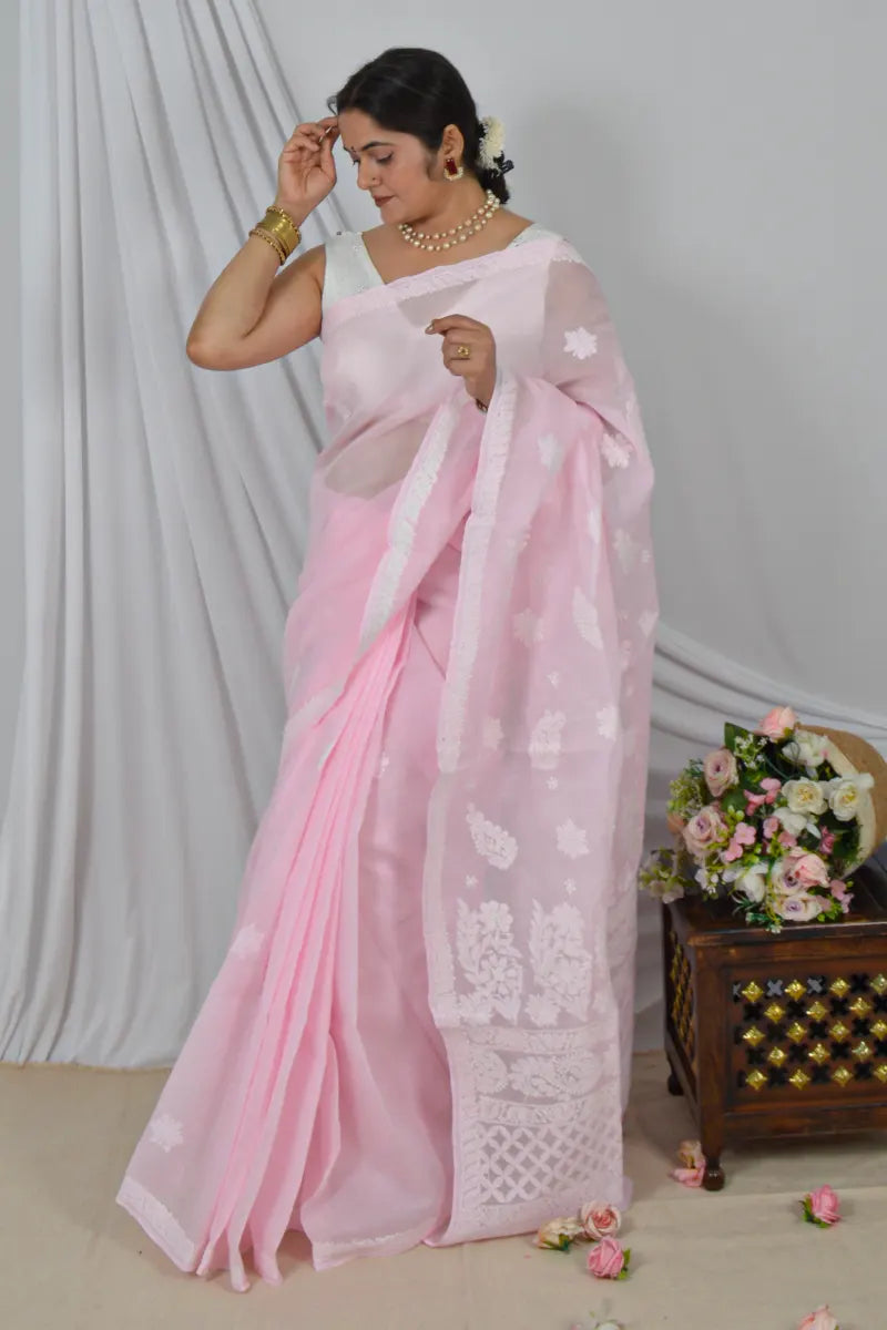Woman wearing Memaana Handcrafted Pink Cotton Border Palla Chikankari Saree with Blouse in soft pink color.