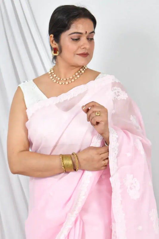 Woman draped in Memaana Handcrafted Pink Cotton Border Palla Chikankari Saree with matching blouse and pearl necklace