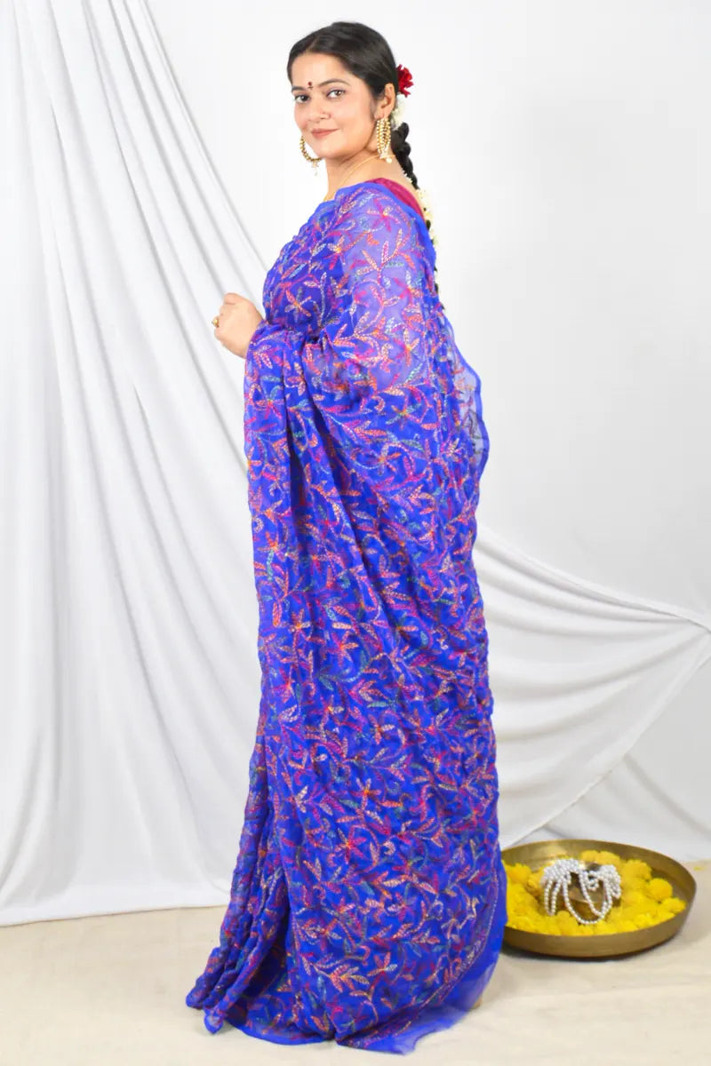 Handcrafted Royal Blue Georgette Tepchi saree intricate Lucknowi Chikankari embroidery and a matching blouse, ideal for festive and wedding occasions.