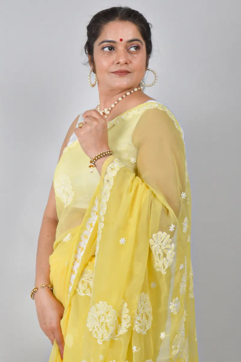 Yellow georgette saree with allover Lucknowi Chikankari and matching blouse – handcrafted festive wear by MeMaana.