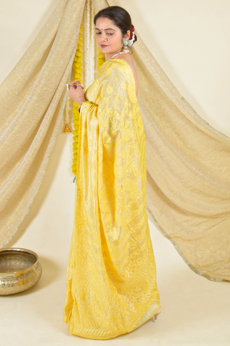 Handcrafted yellow tussar silk chikankari saree with blouse by Fabnuma