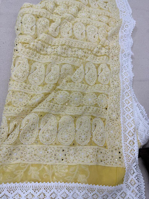 Embroidered fabric with intricate patterns on a gray background