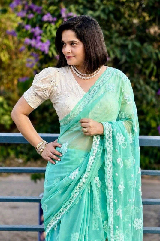 Close view of MeMaana green georgette chikankari saree showing detailed hand embroidery