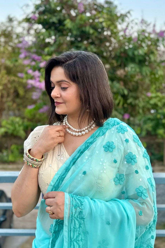 Elegant pastel chikankari saree styling with pearl jewelry
