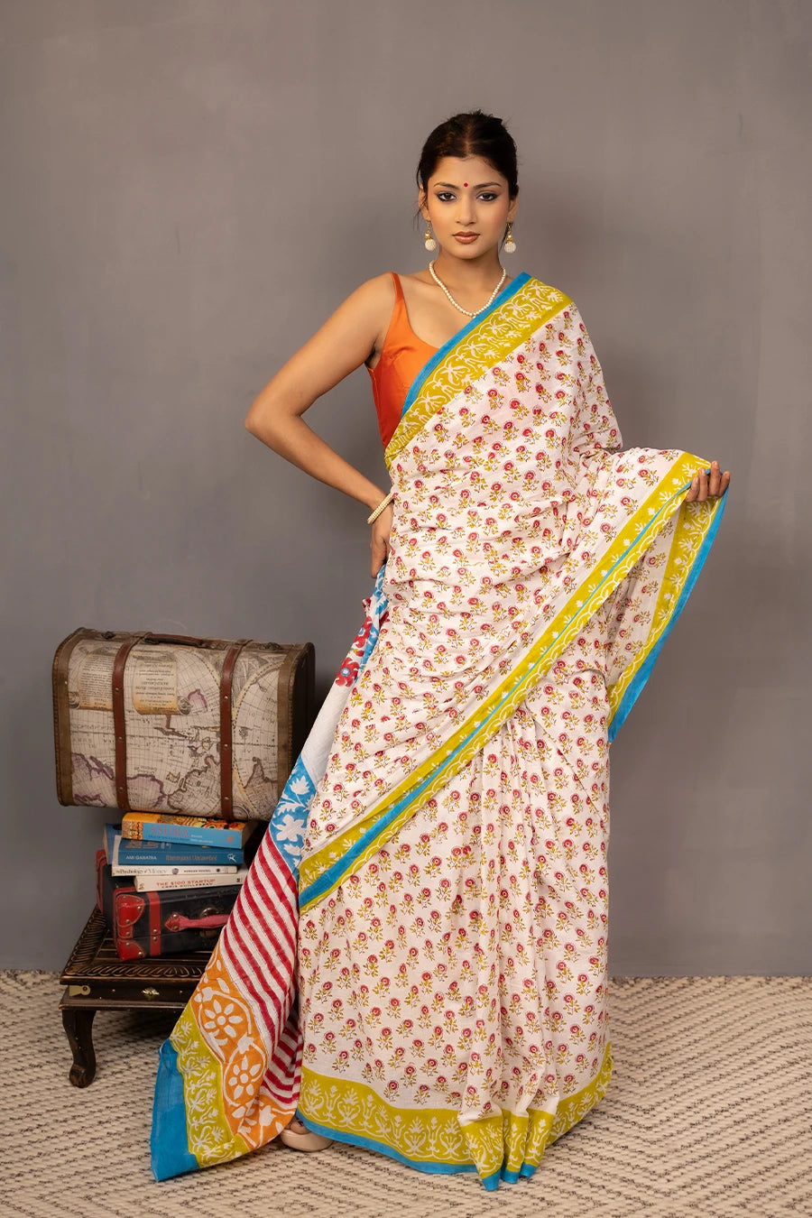 Woman wearing a colorful saree with a grey background