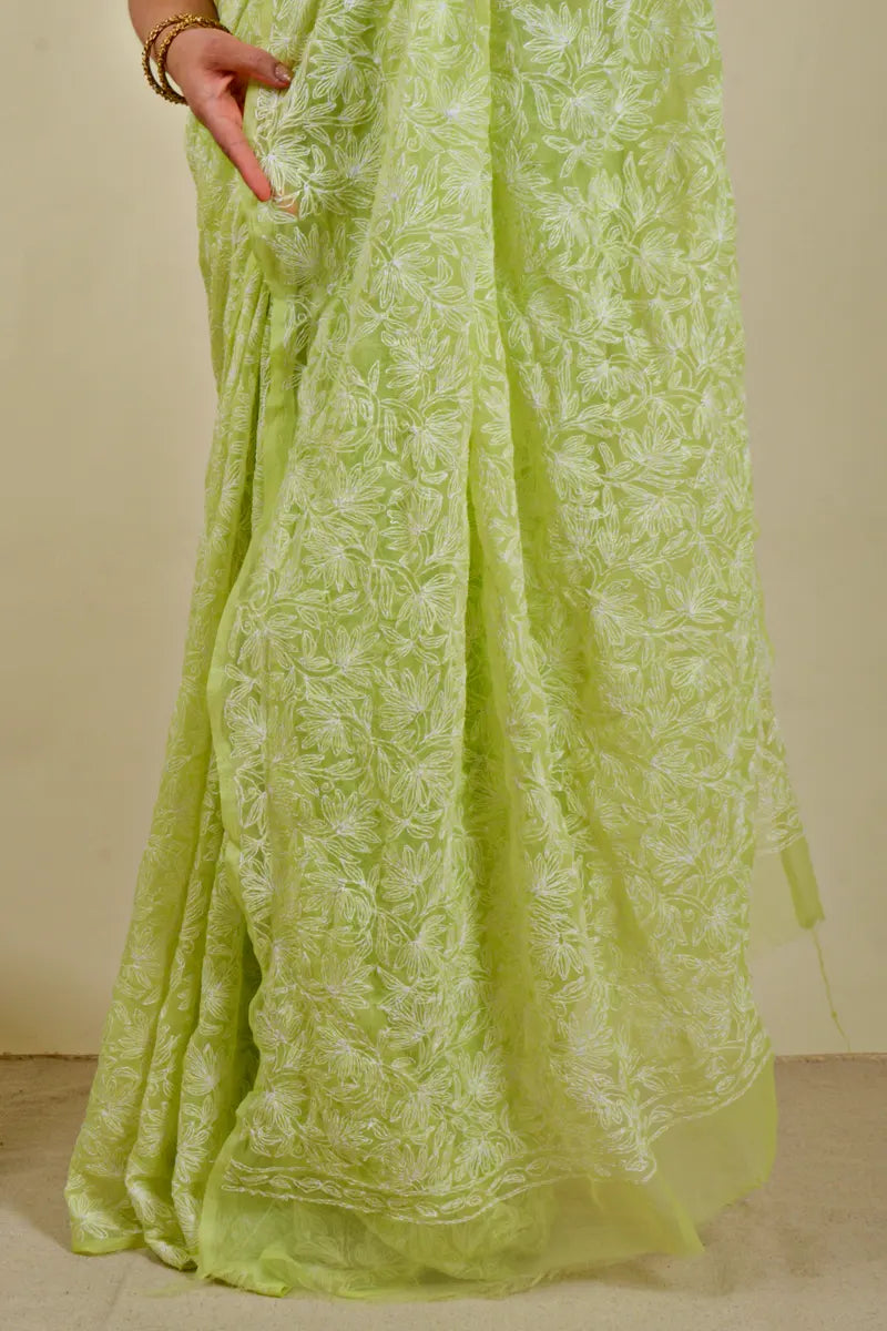 Handcrafted Green Georgette Saree with intricate Lucknowi Mukaish 
 Tepchi Chikankari embroidery and a matching blouse, ideal for festive and wedding occasions.