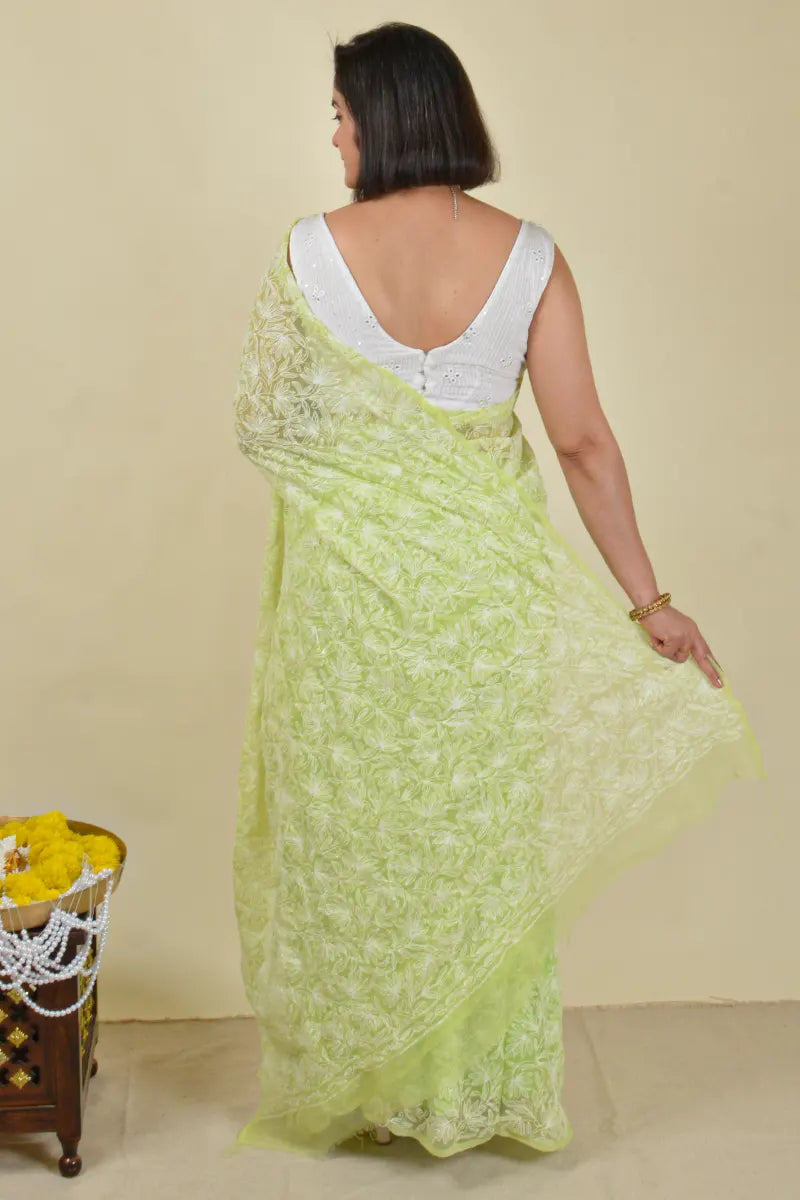 Handcrafted Green Georgette Saree with intricate Lucknowi Mukaish 
 Tepchi Chikankari embroidery and a matching blouse, ideal for festive and wedding occasions.