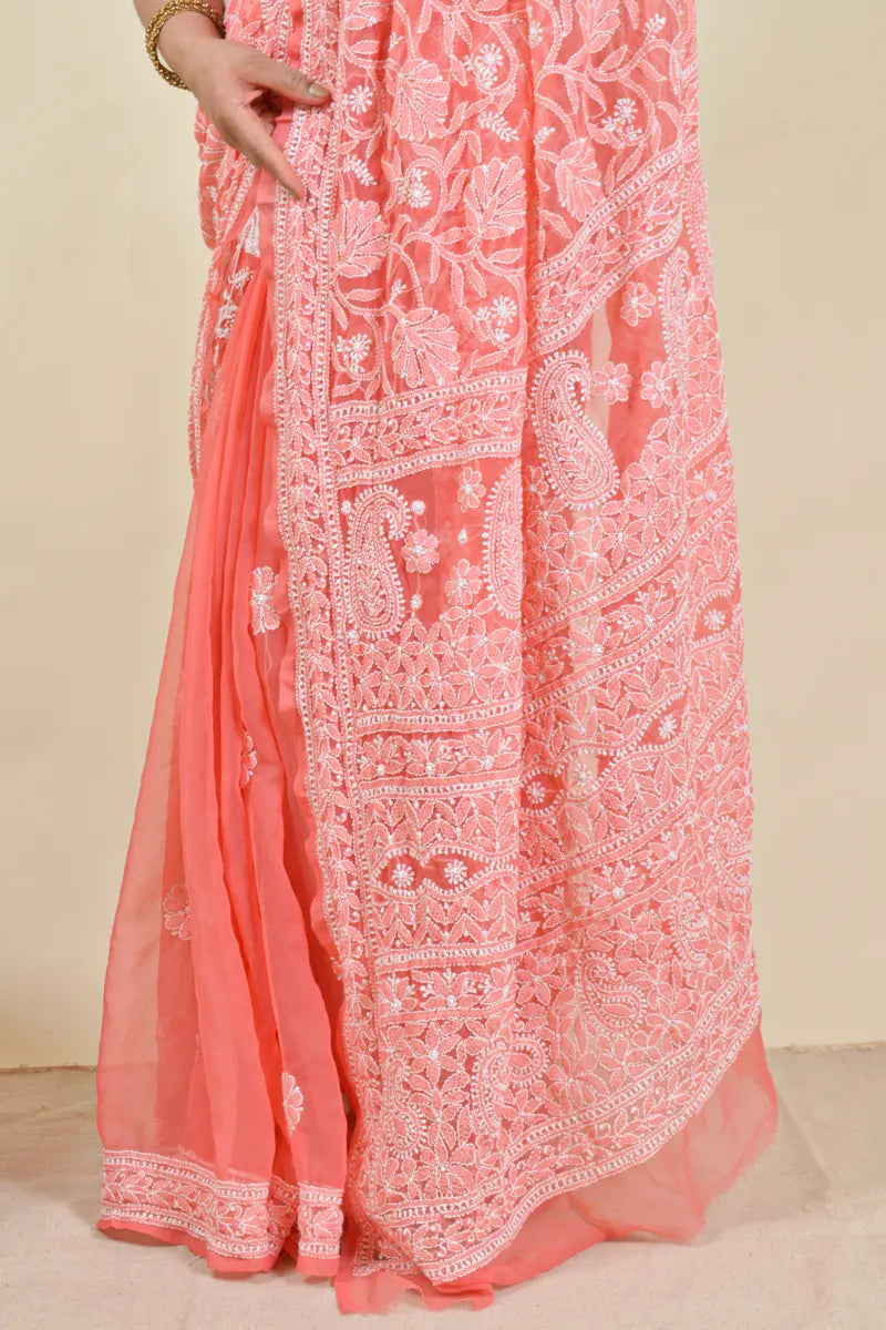 Handcrafted Orange saree with intricate Lucknowi Chikankari embroidery and a matching blouse, ideal for festive and wedding occasions.
