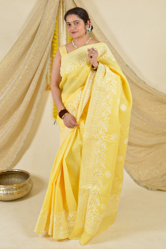 Handcrafted Yellow Cotton saree with intricate Lucknowi Chikankari embroidery and matching blouse, ideal for weddings and festive occasions.

