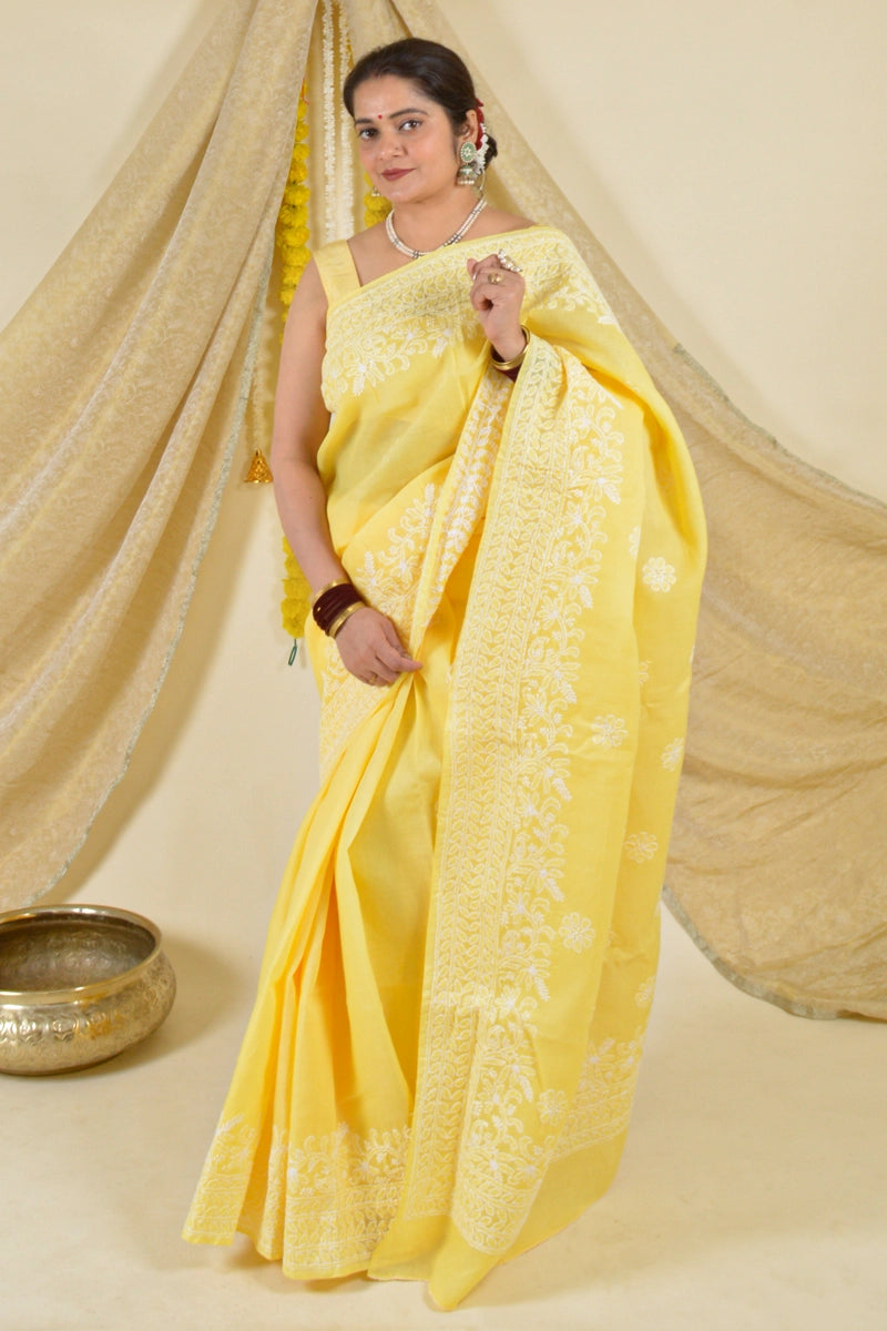 Handcrafted Yellow Cotton saree with intricate Lucknowi Chikankari embroidery and matching blouse, ideal for weddings and festive occasions.

