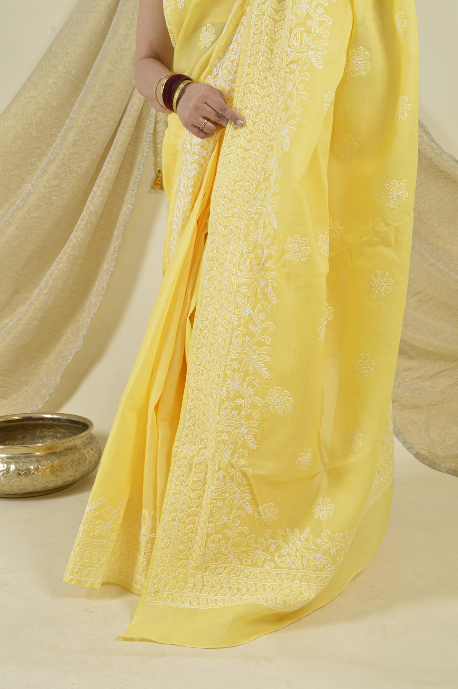 Handcrafted Yellow Cotton saree with intricate Lucknowi Chikankari embroidery and matching blouse, ideal for weddings and festive occasions.
