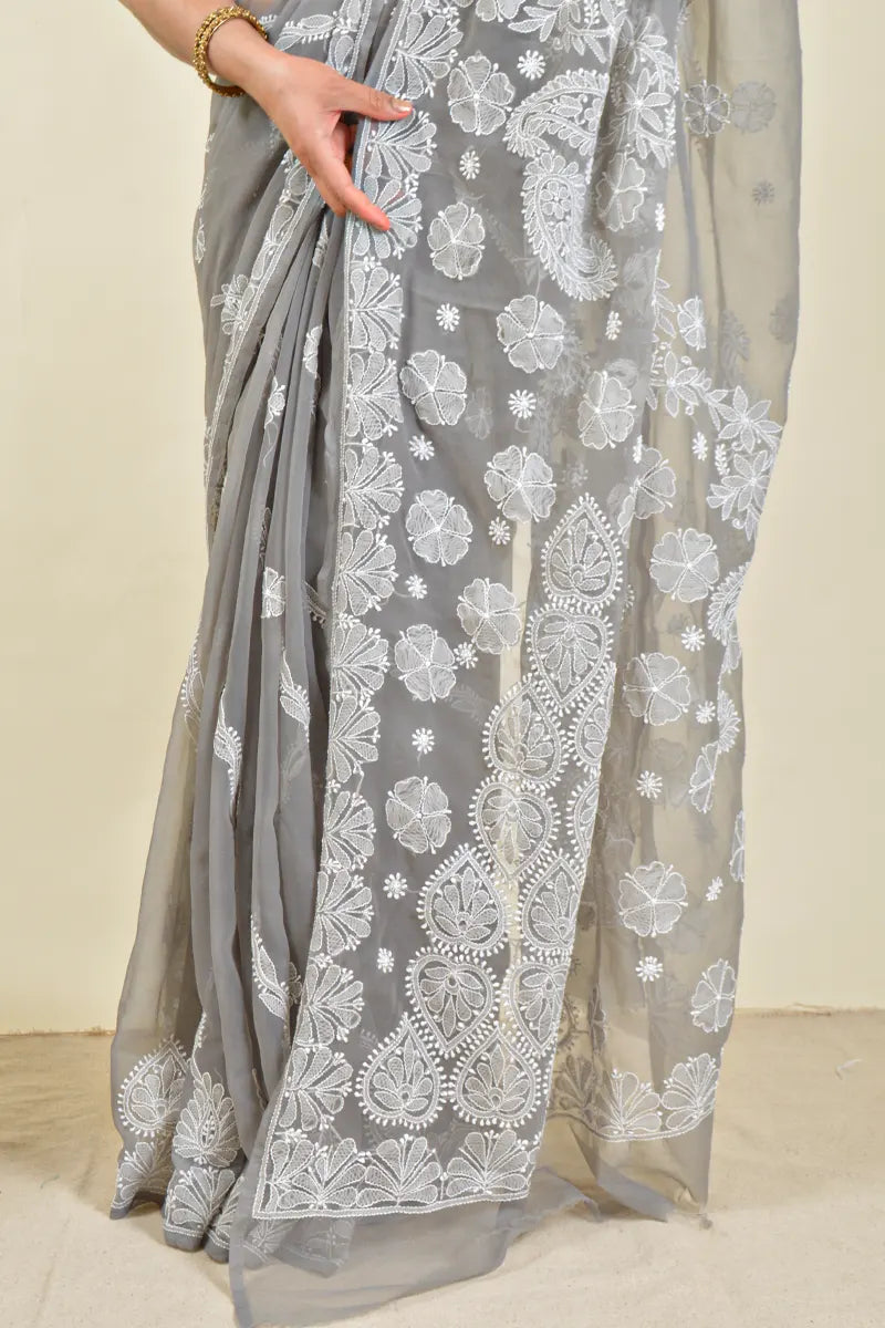 Handcrafted Gray Georgette saree with intricate Lucknowi Chikankari embroidery and a matching blouse, ideal for festive and wedding occasion