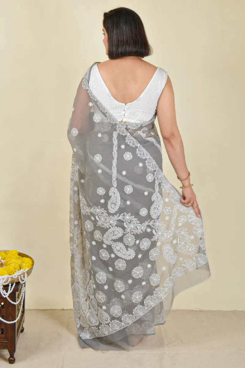 Handcrafted Gray Georgette saree with intricate Lucknowi Chikankari embroidery and a matching blouse, ideal for festive and wedding occasion