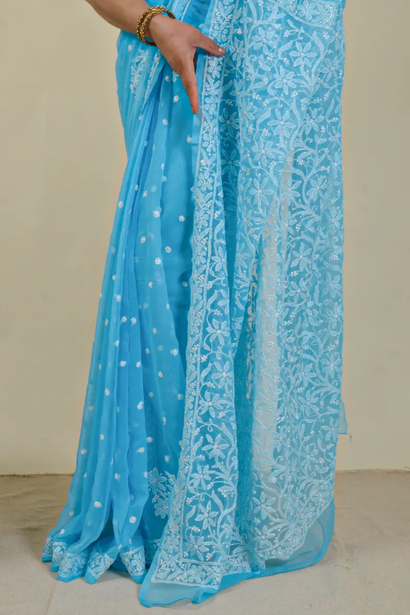 Handcrafted Sky Blue saree with intricate Lucknowi Chikankari embroidery and a matching blouse, ideal for festive and wedding occasions.