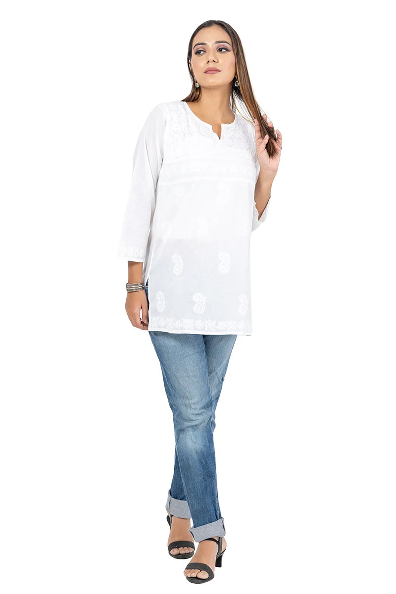 Fabnuma Handcrafted Chikankari White Short Cotton Kurti with intricate embroidery and 3/4 sleeves modeled with jeans.