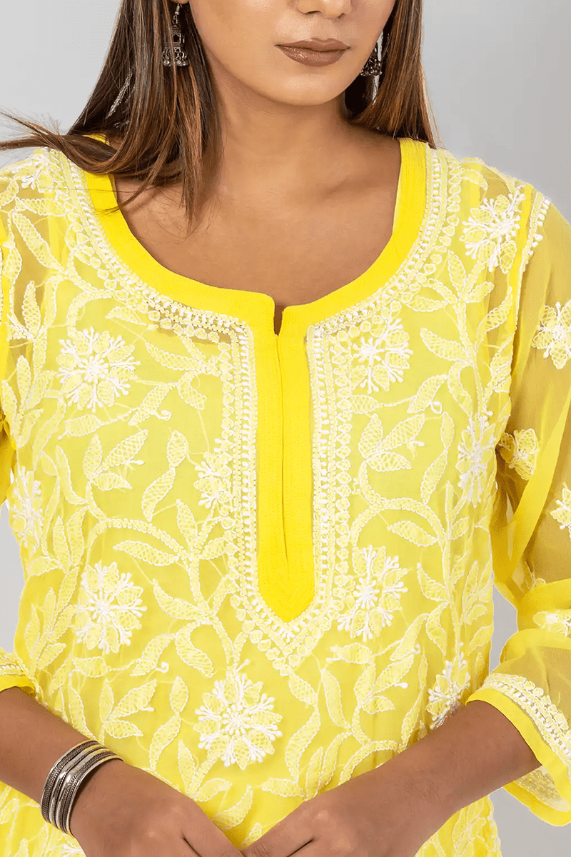Fabnuma Handcrafted Chikankari Yellow Georgette Short Top with intricate white embroidery and cotton thread detailing.
