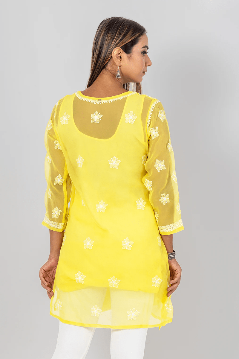 Fabnuma Handcrafted Chikankari Yellow Georgette Short Top with white floral embroidery on sheer sleeves and back panel.