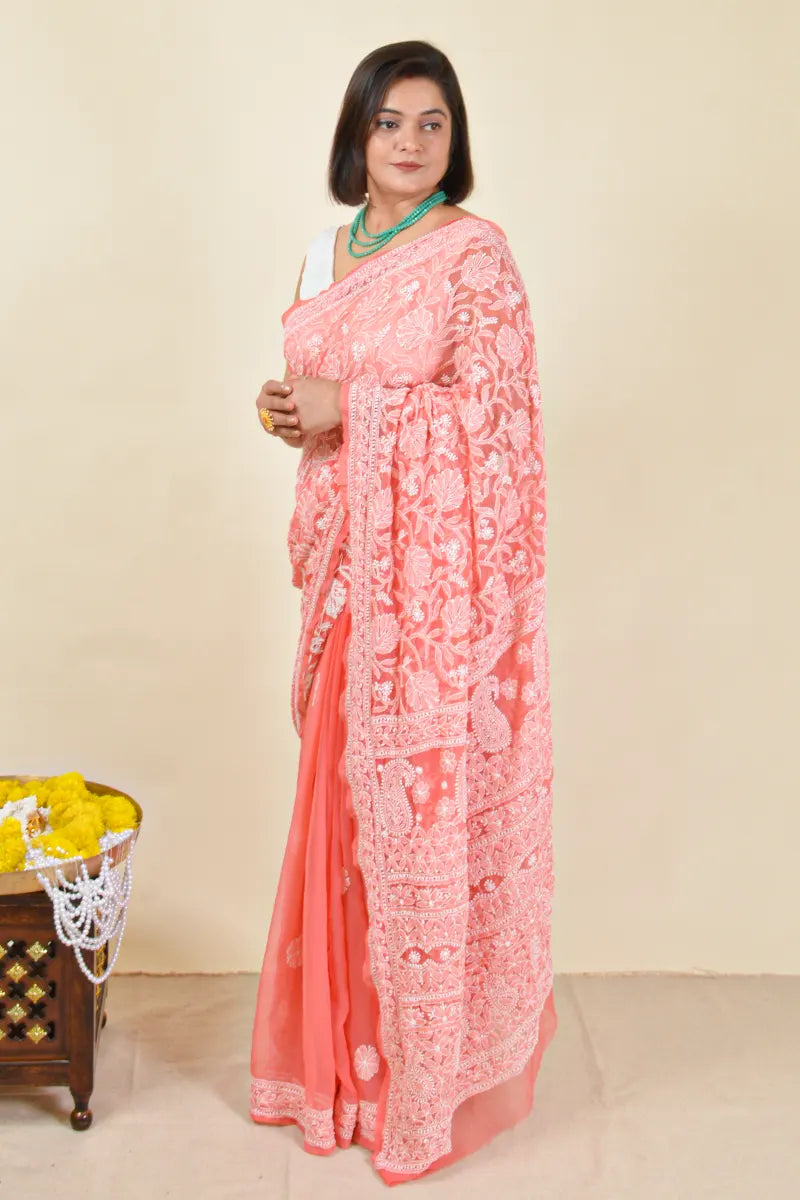 Handcrafted Orange saree with intricate Lucknowi Chikankari embroidery and a matching blouse, ideal for festive and wedding occasions.