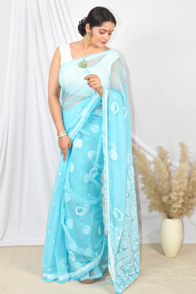 Handcrafted Sky Blue Georgette saree with Pearl & Sequin Work intricate Lucknowi Chikankari embroidery and a matching blouse, ideal for festive and wedding occasions.