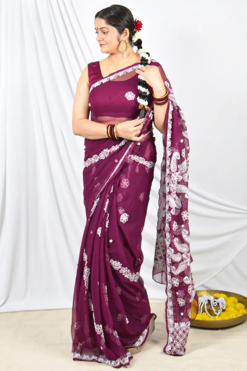Handcrafted Wine Georgette saree with intricate Lucknowi Chikankari embroidery and a matching blouse, ideal for festive and wedding occasions.

