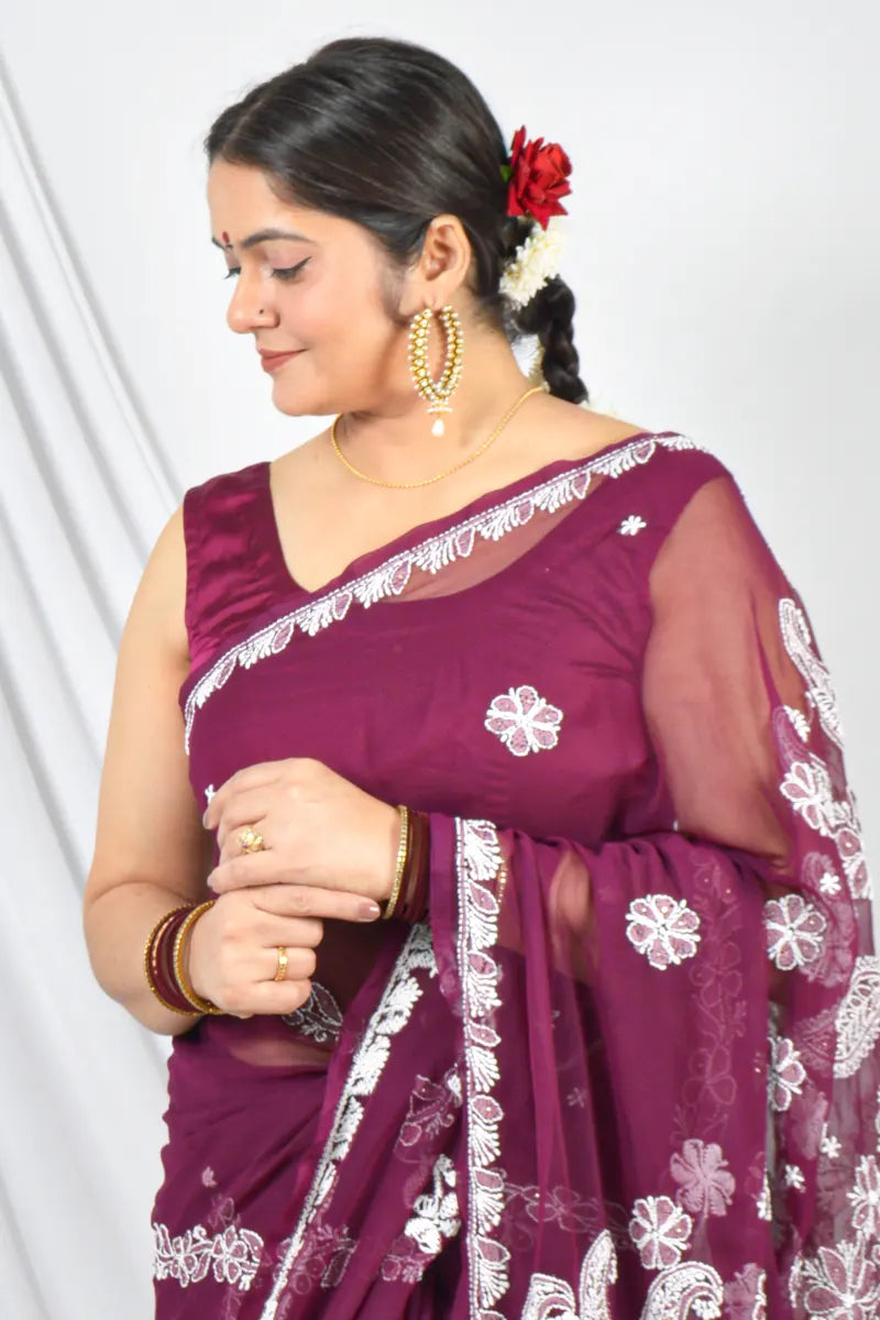 Handcrafted Wine Georgette saree with intricate Lucknowi Chikankari embroidery and a matching blouse, ideal for festive and wedding occasions.

